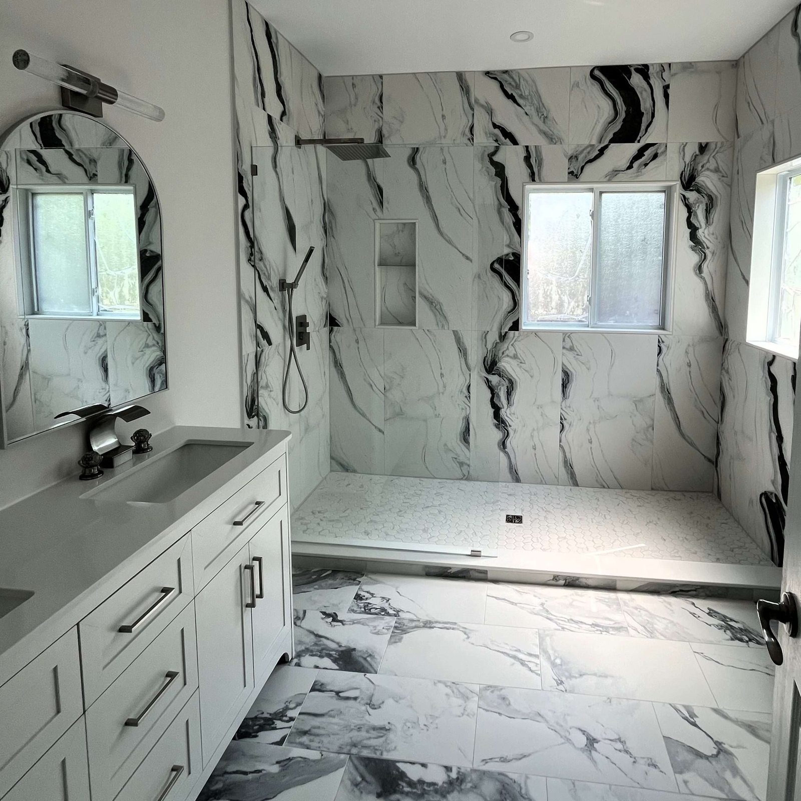 Marble ensuite bathroom with a floating vanity and frameless glass shower
